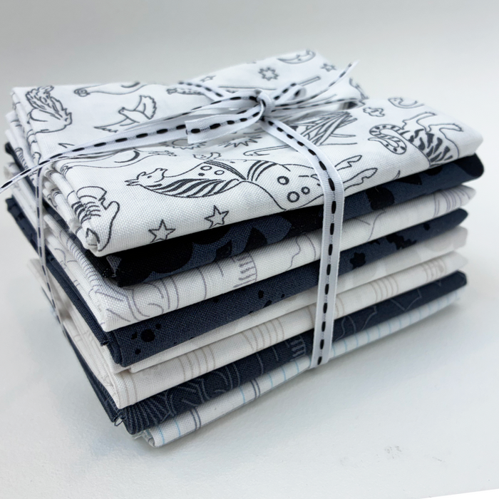 Stack of folded fabric with animal prints tied with a ribbon on a white background