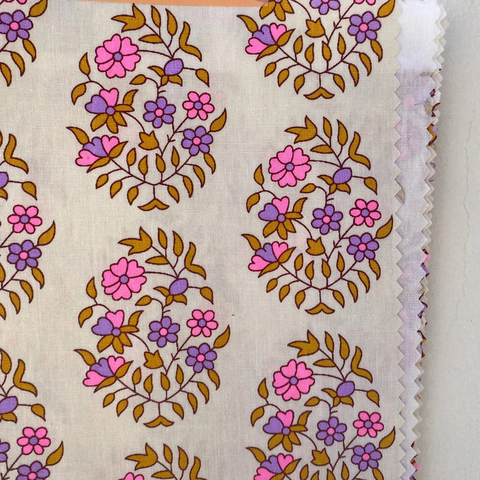 Fabric swatch with floral pattern on a beige background