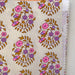 Fabric swatch with floral pattern on a beige background