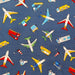 close up of fabric with trucks, planes, busses and construction vehicles
