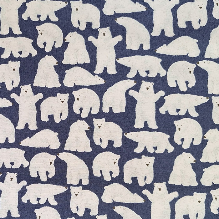 close up of fabric with white polar bears in different positions on a dark blue background