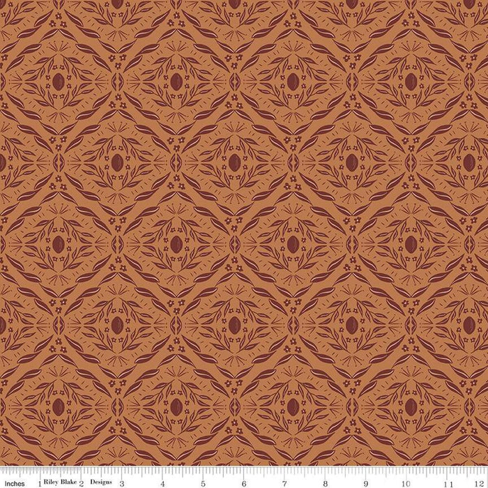 Brown fabric with a diamond pattern and a ruler at the bottom for scale.