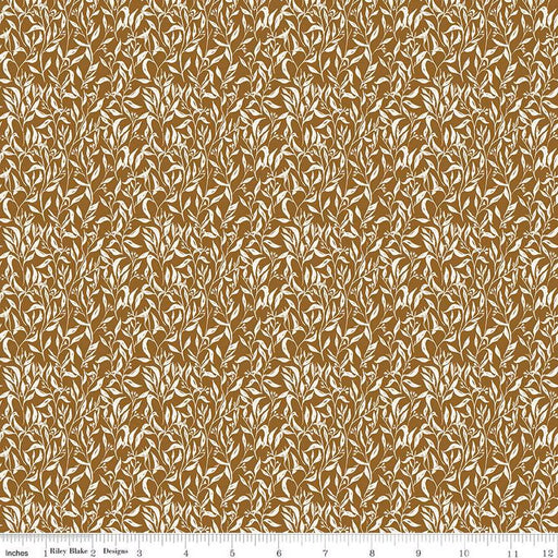 Brown and beige floral patterned fabric with a ruler at the bottom