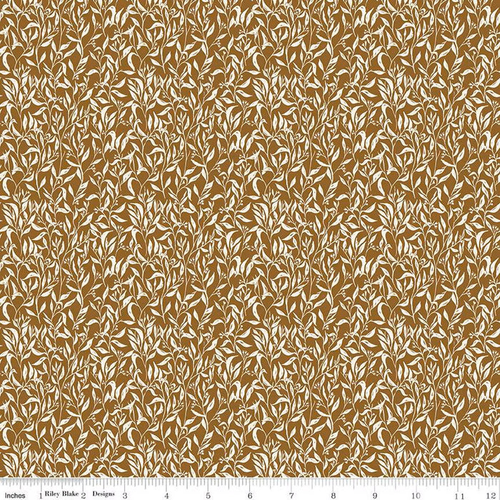 Brown and beige floral patterned fabric with a ruler at the bottom