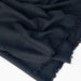 Black fabric with frayed edges on a white background