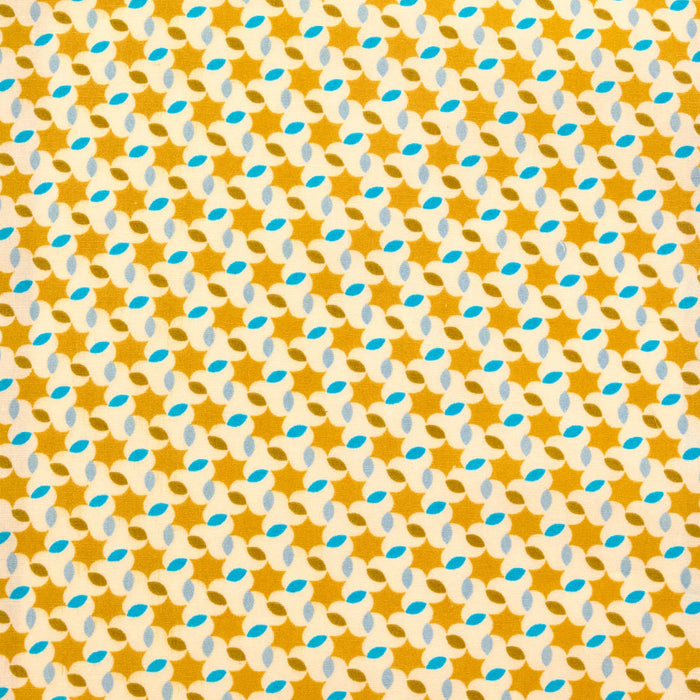Patterned fabric with a star and leaf design on a yellow background