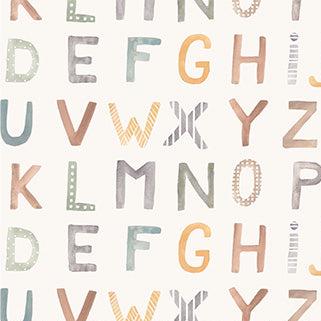 An alphabet painted in hues of gold, brown, and greens on white fabrics.
