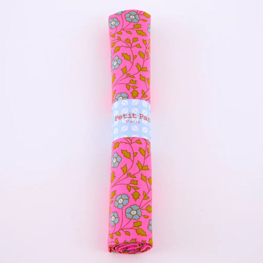 Rolled-up pink fabric with floral pattern on a white background