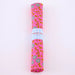 Rolled-up pink fabric with floral pattern on a white background