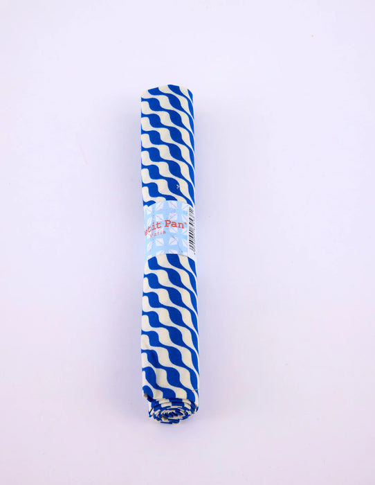 Roll of blue and white striped paper on a light purple background