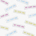 Multiple 'Eat Sleep Sew' labels in various colors on a white background