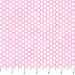 Pink fabric with white polka dots and a ruler at the bottom for scale.