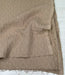 Brown textured fabric with frayed edges on a white background