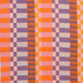 close up shot of yarn dyed fabric in pink orange and purple with varying size checks