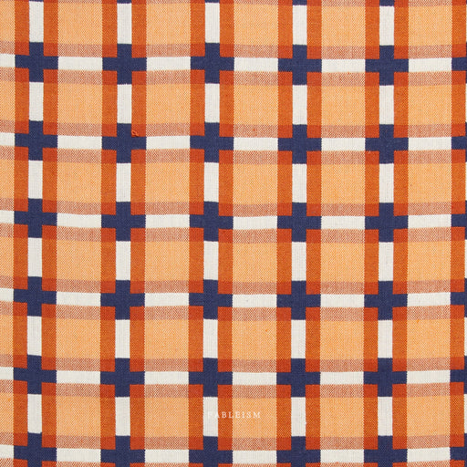 Plaid pattern with orange, blue, and white colors on a fabric background