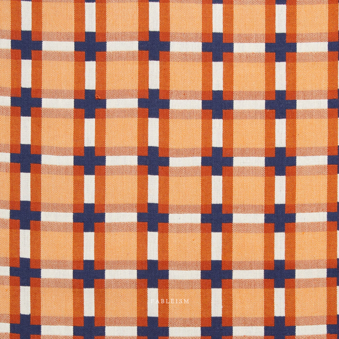 Plaid pattern with orange, blue, and white colors on a fabric background