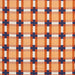 Plaid pattern with orange, blue, and white colors on a fabric background