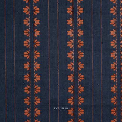 Navy fabric with orange floral pattern and 'Fableism' branding