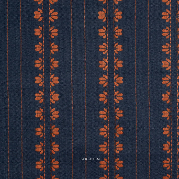 Navy fabric with orange floral pattern and 'Fableism' branding
