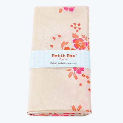 Floral-patterned towel with 'Petit Pan' label on a white background
