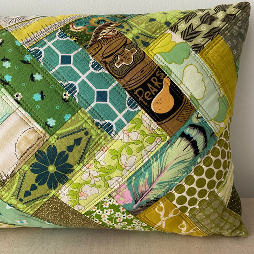 Patchwork pillow with various patterns on a neutral background
