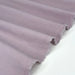 A close-up of draped dusty purple fabric with a frayed, raw edge, shown against a plain white background.