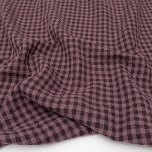 Close-up of purple checkered fabric on a white background