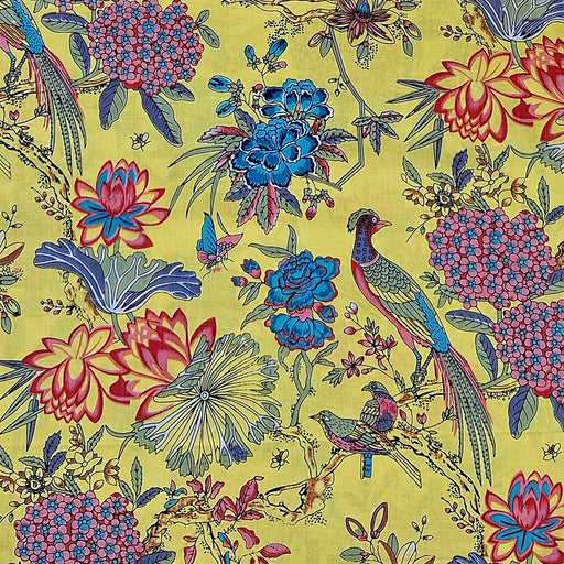 A close-up of a fabric  pattern featuring a classic Indian-style floral and bird design on a bright yellow background. The print includes blue lotus flowers, pink hydrangeas, blue birds, and green foliage.