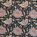 A close-up of a black patterned fabric featuring large pink and white floral motifs with gold and brown vine details.