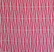 A close-up of a repeating fabric pattern featuring vertical wavy graphic in alternating bright pink and off-white sections.