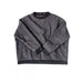 Quilted gray sweater on a white background