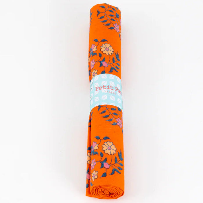 Orange floral-patterned rolled fabric on a white background