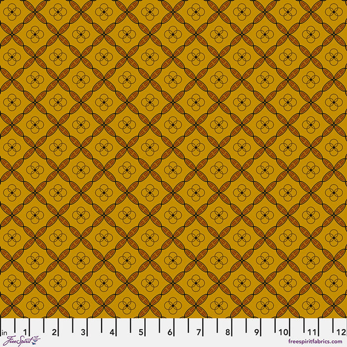 Patterned fabric swatch with a grid and floral design on a yellow background, featuring a ruler at the bottom.