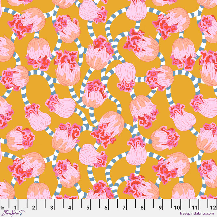 Pattern of pink and peach flowers with green leaves on a mustard yellow background, with a ruler at the bottom.