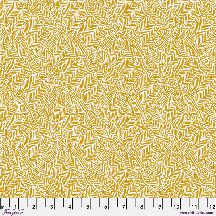 Yellow fabric pattern with a ruler at the bottom for scale