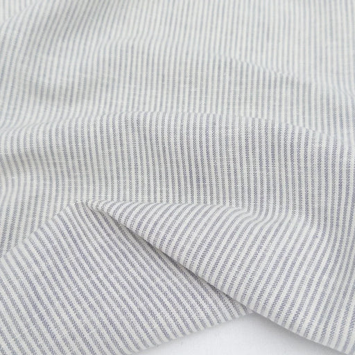 Close-up of gray striped fabric with a white background