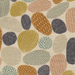 A close-up of a fabric pattern featuring organic, abstract shapes in mustard yellow, terracotta orange, dusty pink, sage green, and charcoal gray on a warm cream background.