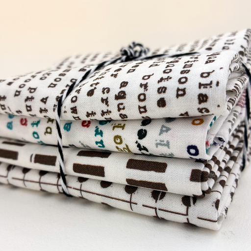 Stack of folded fabric with letter pattern on a white background