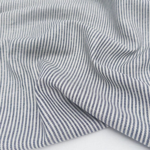 Close-up of blue and white striped fabric on a white background