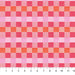 Checkered fabric pattern with pink and orange squares, measured against a ruler.