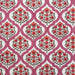 Patterned fabric with red floral design on a pink background