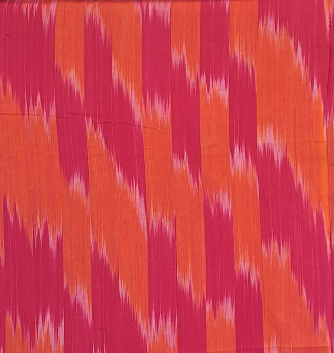 Close up of Ikat Woven Cotton in Orange and Fuchsia 
